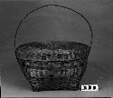 Carrying basket with lid. From the collection of the brothers of Mrs. J.M. Robinson, 1883-1925. Plain plaited.