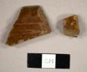 Refined redware sherds with clear and brown lead glaze, including one possible pan rim sherd