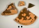 Lead-glazed redware sherds, including base and rim sherds to a possible crock or milk pan