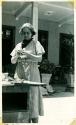 Scan of photograph from Judge Burt Cosgrove photo album.Madeline Kidder at work in the patio. 3/25/38
