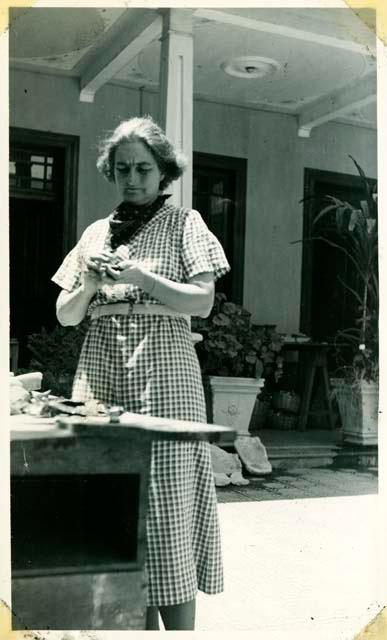 Scan of photograph from Judge Burt Cosgrove photo album.Madeline Kidder at work in the patio. 3/25/38
