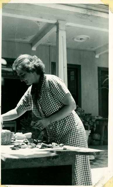 Scan of photograph from Judge Burt Cosgrove photo album.Madeline Kidder at work in the patio. 3/25/38

