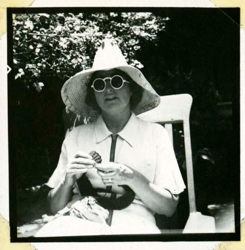 Scan of photograph from Judge Burt Cosgrove photo album.Madeleine K Knitting in the sun