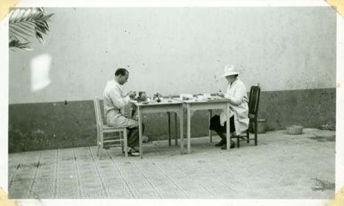 Scan of photograph from Judge Burt Cosgrove photo album.Paul Richard H.S.C. Mending pottery