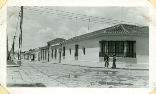 Scan of photograph from Judge Burt Cosgrove photo album.Across the street from the Pension 9th Avenida Sur