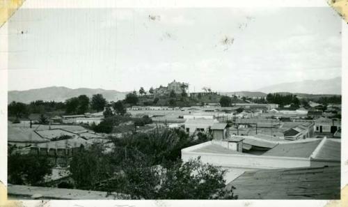 Scan of photograph from Judge Burt Cosgrove photo album.Across roof tops to Cerro del Carmen