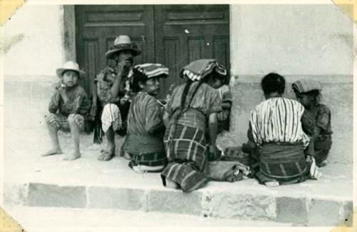 Scan of photograph from Judge Burt Cosgrove photo album.Family having lunch on sidewalk