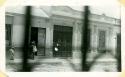 Scan of photograph from Judge Burt Cosgrove photo album.Father and son. Burden bags hang by forehead strap.