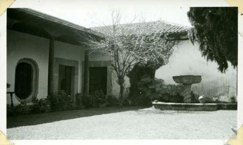 Scan of photograph from Judge Burt Cosgrove photo album.Fountain in the patio