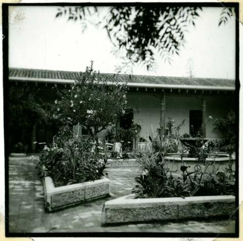 Scan of photograph from Judge Burt Cosgrove photo album.Patio in Aurora Hotel