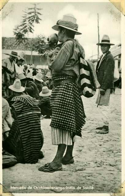 Scan of photograph from Judge Burt Cosgrove photo album.Solola man Red cloth on hat, red shirt, black and white apron. Red and white pants Black and white wool bag