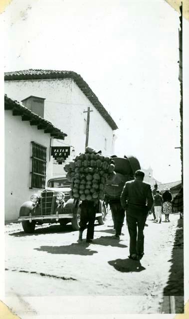 Scan of photograph from Judge Burt Cosgrove photo album.Taking pottery to market Chichicastenango