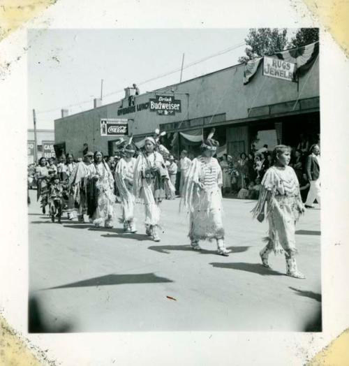 Scan of photograph from Judge Burt Cosgrove photo album.Ponca women in parade