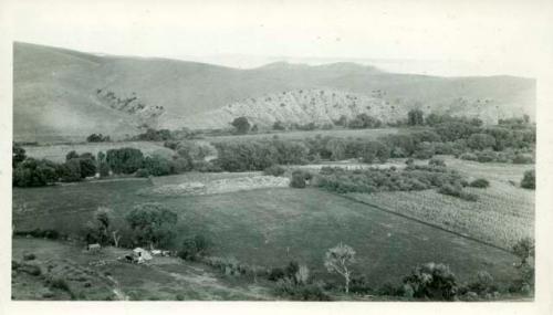 Scan of photograph from Judge Burt Cosgrove photo album.Camp 1925.  To east, Mimbres Valley (Swarts Ruin in alfalfa field center of picture)