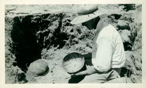 Scan of photograph from Judge Burt Cosgrove photo album.Lifting bowl, burial at Swarts Ruin

