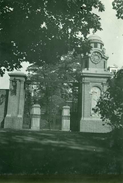 Scan of photograph from Judge Burt Cosgrove photo album.Gate opposite Harvard Union