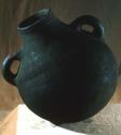 Large black pot with two handles and a wrapped grass plug, Circ. 43 1/8"