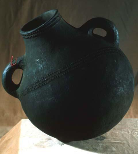 Large black pot with two handles and a wrapped grass plug, Circ. 43 1/8"