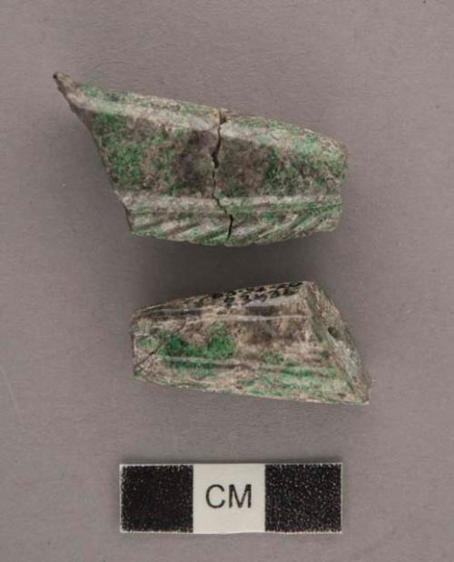 Two fragments of dark green and white and gray jade carved oblong beads