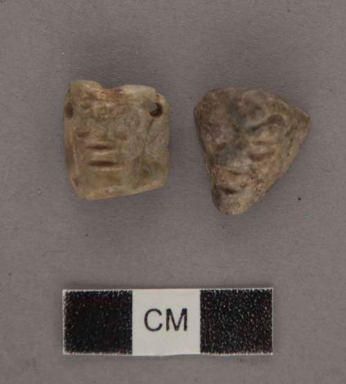 Ground stone; 2 effigy heads; both perforated