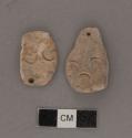 Ground stones; ornaments; pendants; incised circular dsigns, one side