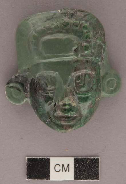 Portion of carved jadeite ornament, human face