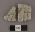 Engraved jadeite fragment, human hand