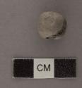 Ground stone bead, round, broken.