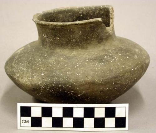 Ceramic jar, plain with punctate ring at base, sherds missing at rim