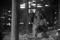 Samuel Putnam negatives, New Guinea.Inside a hunu at Abulupak; 2 old women; one with a child in her arms sits in the hunu