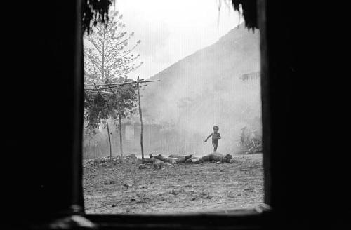 Samuel Putnam negatives, New Guinea. Natorek peeks into the honai in Wuperainma I