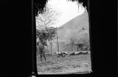 Natorek stands outside the honai in Wuperainma I