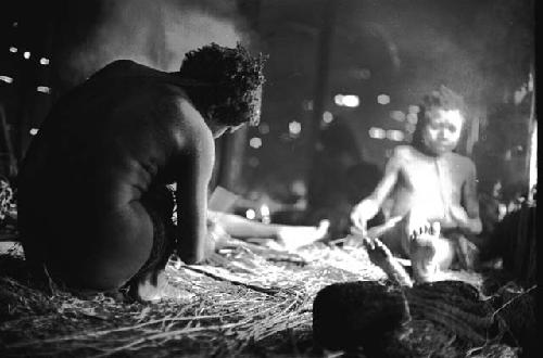 Samuel Putnam negatives, New Guinea. a woman working in the frgd.; other women in the bkgd.