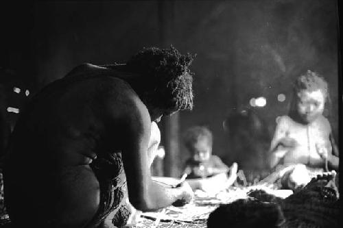 Samuel Putnam negatives, New Guinea.a woman working in the frgd.; other women in the bkgd.