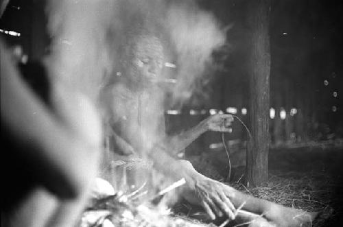 Samuel Putnam negatives, New Guinea.a woman working in the frgd.; other women in the bkgd.