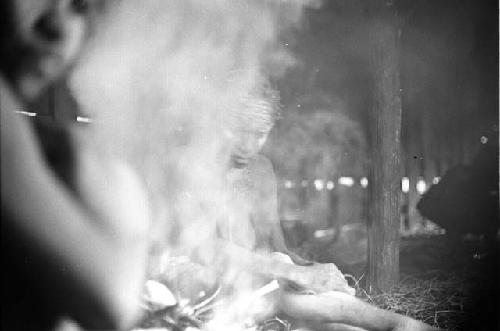 Samuel Putnam negatives, New Guinea.a woman working in the frgd.; other women in the bkgd.