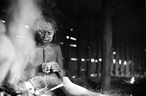 Samuel Putnam negatives, New Guinea.a woman working smoke comes up in front of her