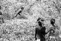 Samuel Putnam negatives, New Guinea.A child raises a spear to throw it at the hoop