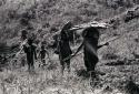 Samuel Putnam negatives, New Guinea.2 women carrying wood down from the Rikumba past Abukulmo