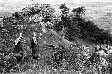 Samuel Putnam negatives, New Guinea. 2 women carrying wood down from the Rikumba past Abukulmo