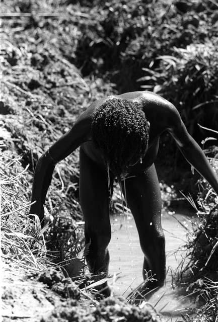 Samuel Putnam negatives, New Guinea.Tukom washing in the little creek