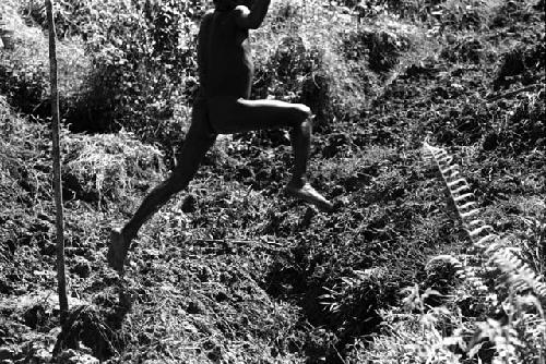 Samuel Putnam negatives, New Guinea.Tukom jumps across a ditch