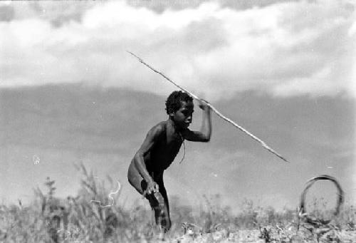 Samuel Putnam negatives, New Guinea. boy about to spear a hoop