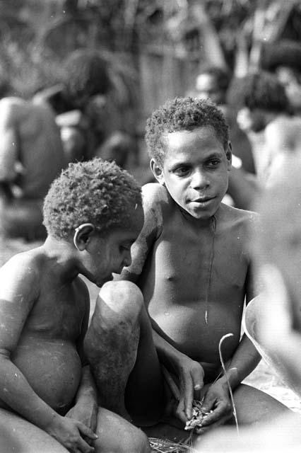 Isile and another little boy talking at the funeral