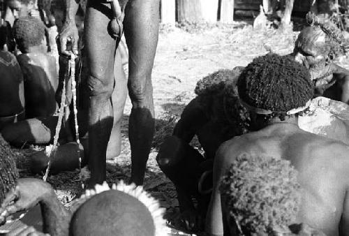 Men with shell strings at funeral