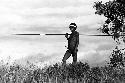 Samuel Putnam negatives, New Guinea; warrior standing in the grass