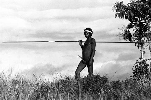 Samuel Putnam negatives, New Guinea; warrior standing in the grass