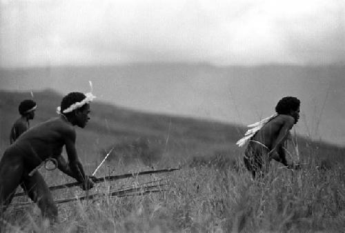 Samuel Putnam negatives, New Guinea; 3 men work upon the Warabara towards the enemy