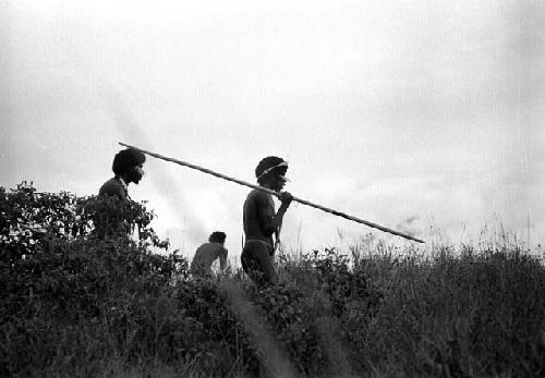 Samuel Putnam negatives, New Guinea; a spearman and others on a ridge waiting for the enemy