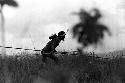 Samuel Putnam negatives, New Guinea; spearman with 2 spears making his way towards the enemy